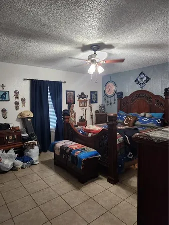 a living room with furniture and a ceiling fan
