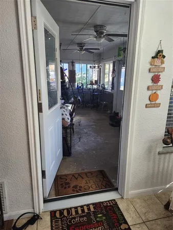 a view of a hallway and a livingroom with furniture