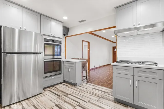 a kitchen with white cabinets and white appliances