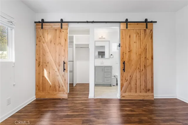 a view of a small space with wooden floor and a window