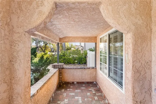 a large white room with a large window and front door