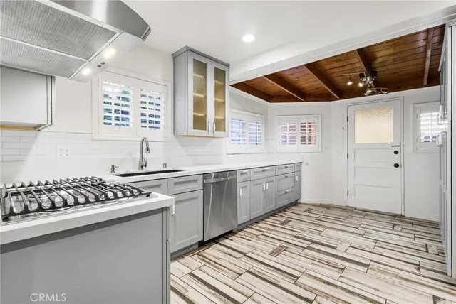 a kitchen with stainless steel appliances a sink stove and cabinets