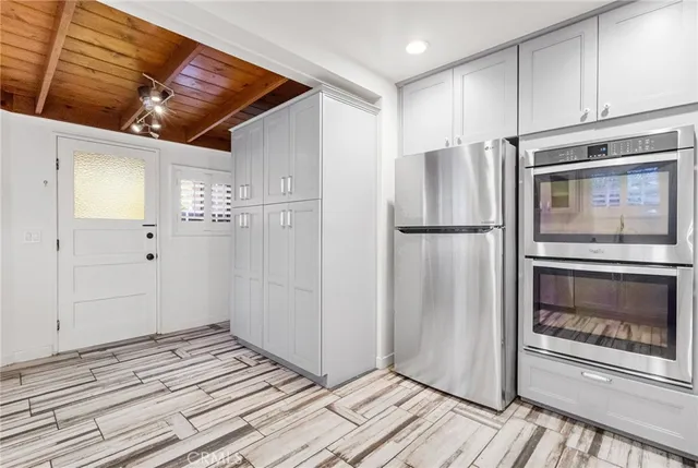 a kitchen with a refrigerator and microwave