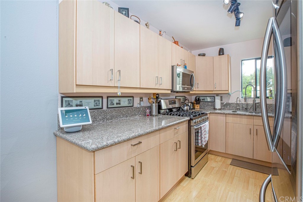 10504 Sunland Boulevard, Unit 5 Sunland, CA 91040 - Photo 14 of 66 a kitchen with stainless steel appliances granite countertop a sink stove and cabinets