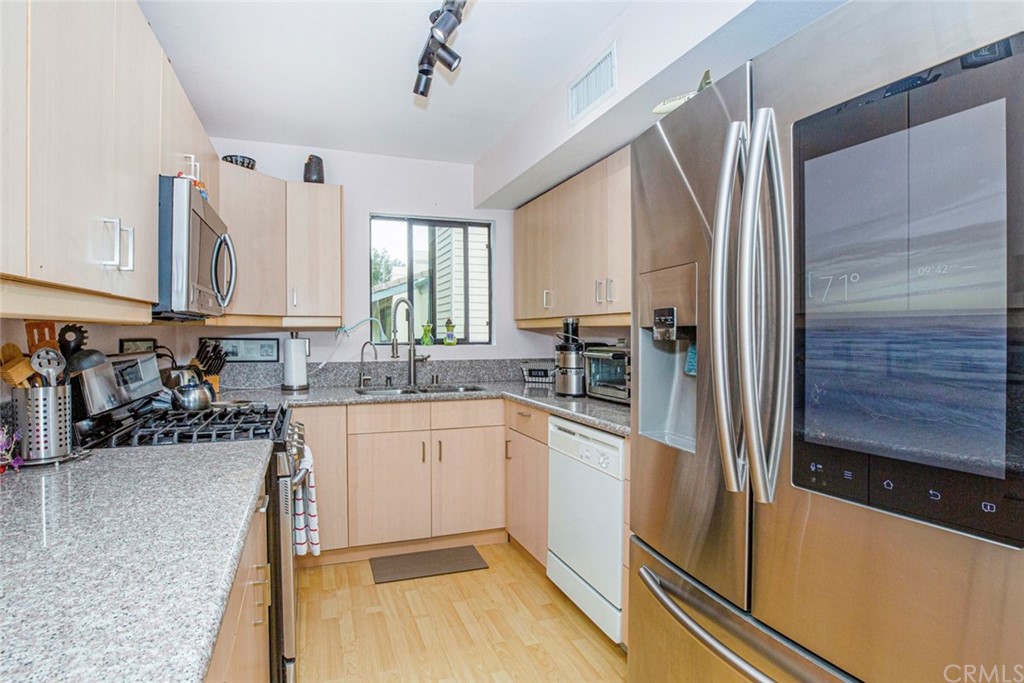 10504 Sunland Boulevard, Unit 5 Sunland, CA 91040 - Photo 15 of 66 a kitchen with sink cabinets and window