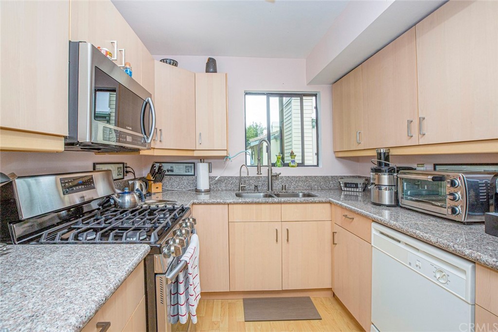 10504 Sunland Boulevard, Unit 5 Sunland, CA 91040 - Photo 16 of 66 a kitchen with granite countertop a sink stove and cabinets