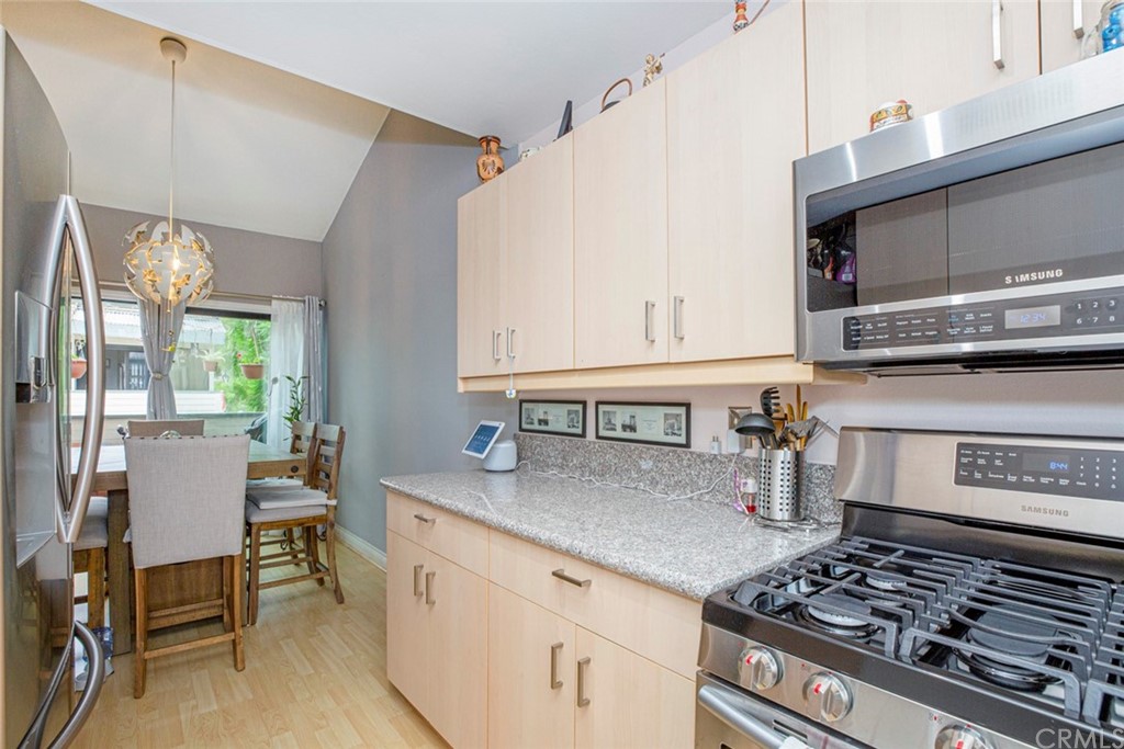 10504 Sunland Boulevard, Unit 5 Sunland, CA 91040 - Photo 17 of 66 a kitchen with stainless steel appliances granite countertop a stove a sink and a microwave