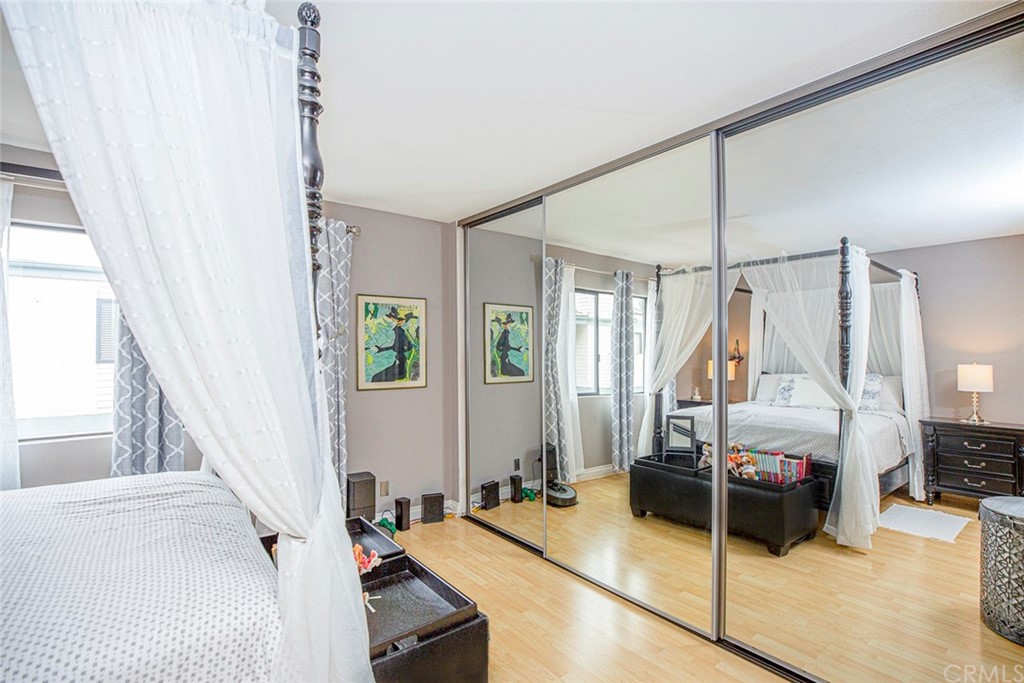 10504 Sunland Boulevard, Unit 5 Sunland, CA 91040 - Photo 23 of 66 a bedroom with a bed window and walk in closet with wooden floor
