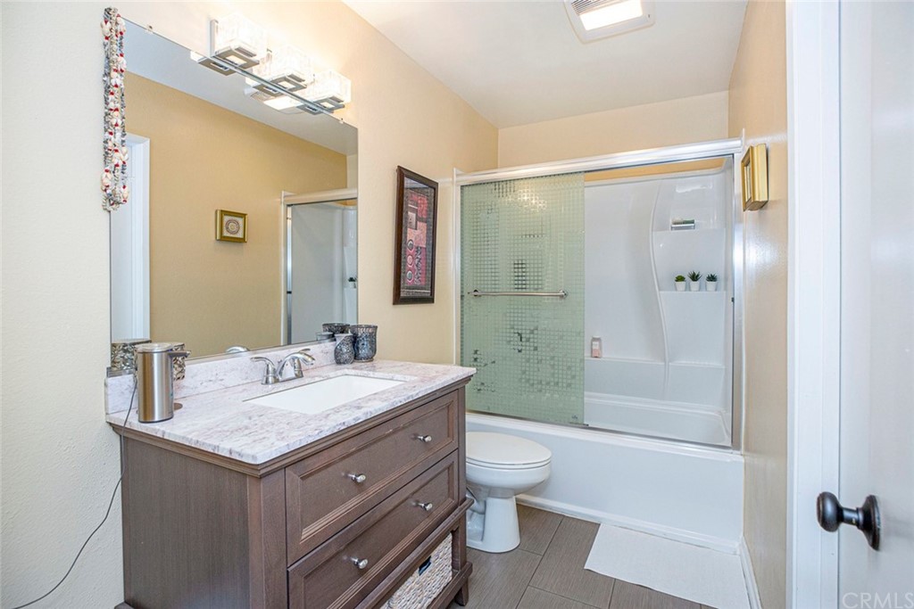 10504 Sunland Boulevard, Unit 5 Sunland, CA 91040 - Photo 26 of 66 a bathroom with a granite countertop sink a toilet a mirror and shower