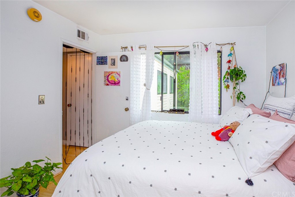10504 Sunland Boulevard, Unit 5 Sunland, CA 91040 - Photo 30 of 66 a bedroom with a bed and a dresser