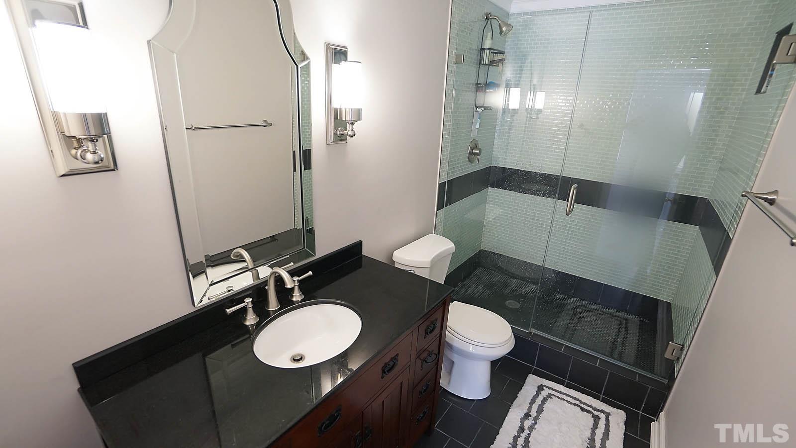 8300 Grey Abbey Place Raleigh, NC 27615 - Photo 10 of 34 Totally updated bath with walk in tiled shower and tile flooring.