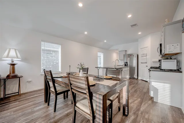 a view of a dining room with furniture and wooden floor