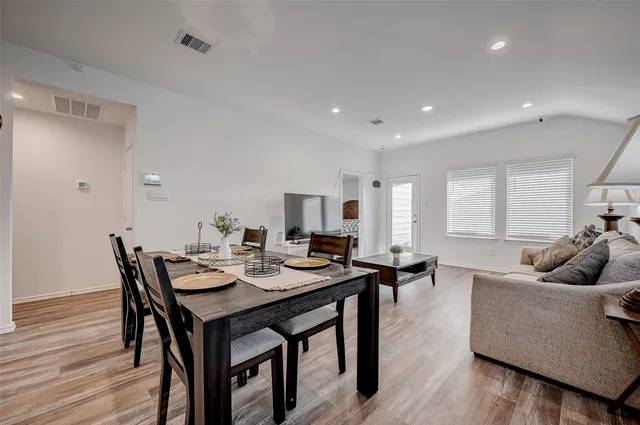 a view of a dining room with furniture and wooden floor