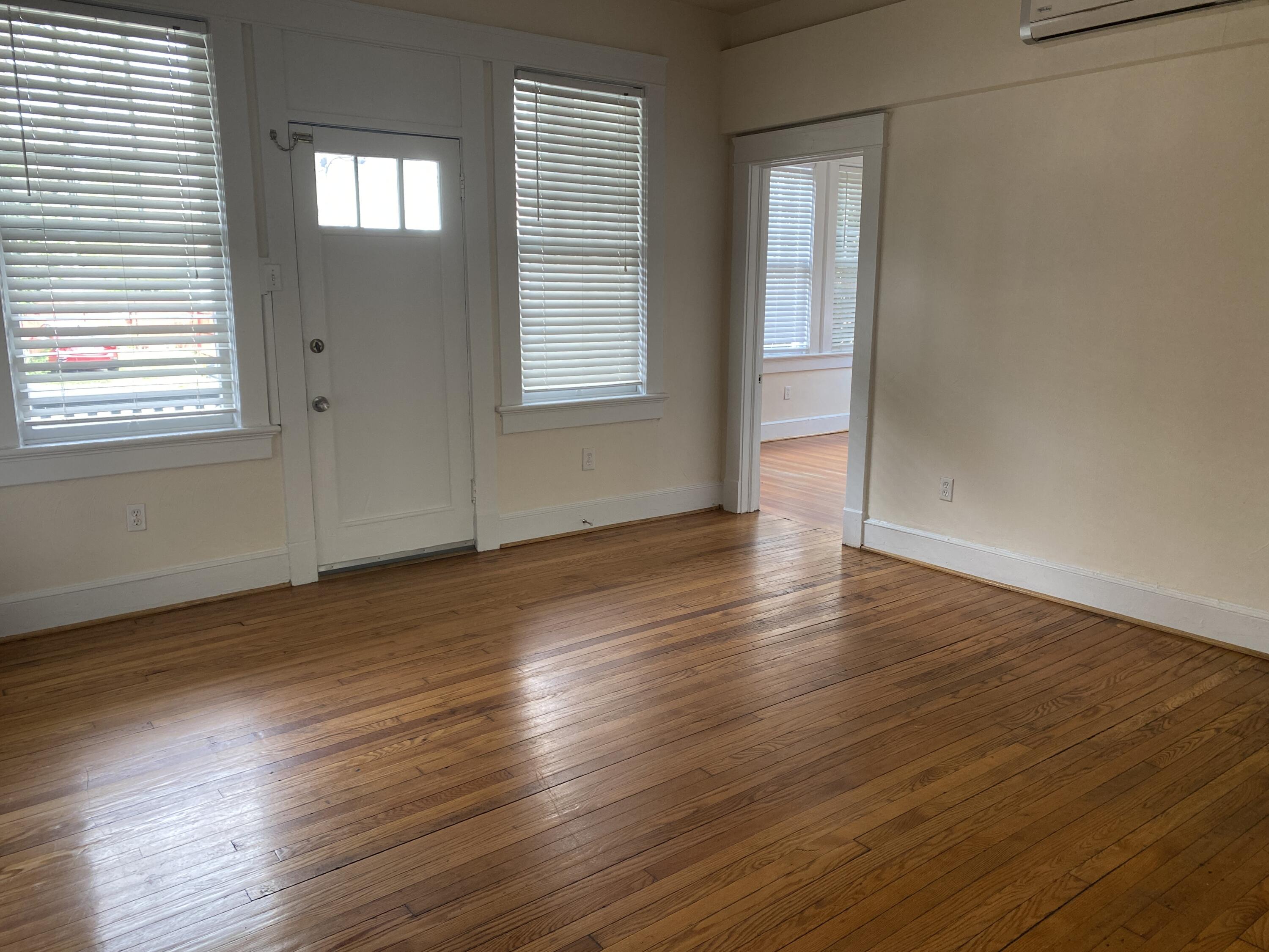 716 4th Street Southwest, Unit 4 Roanoke, VA 24016 - Photo 2 of 10 an empty room with wooden floor and windows
