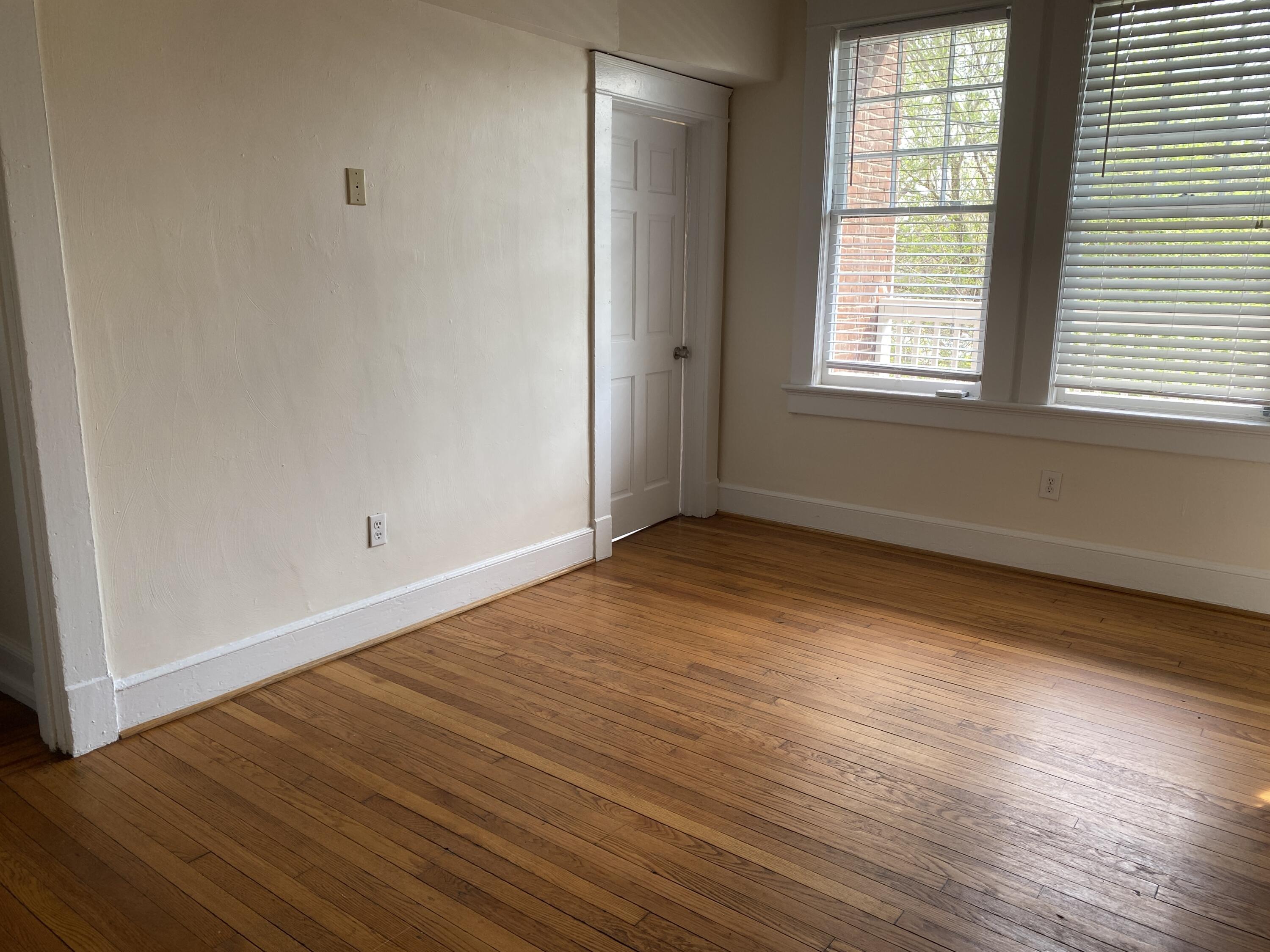 716 4th Street Southwest, Unit 4 Roanoke, VA 24016 - Photo 3 of 10 an empty room with wooden floor and windows