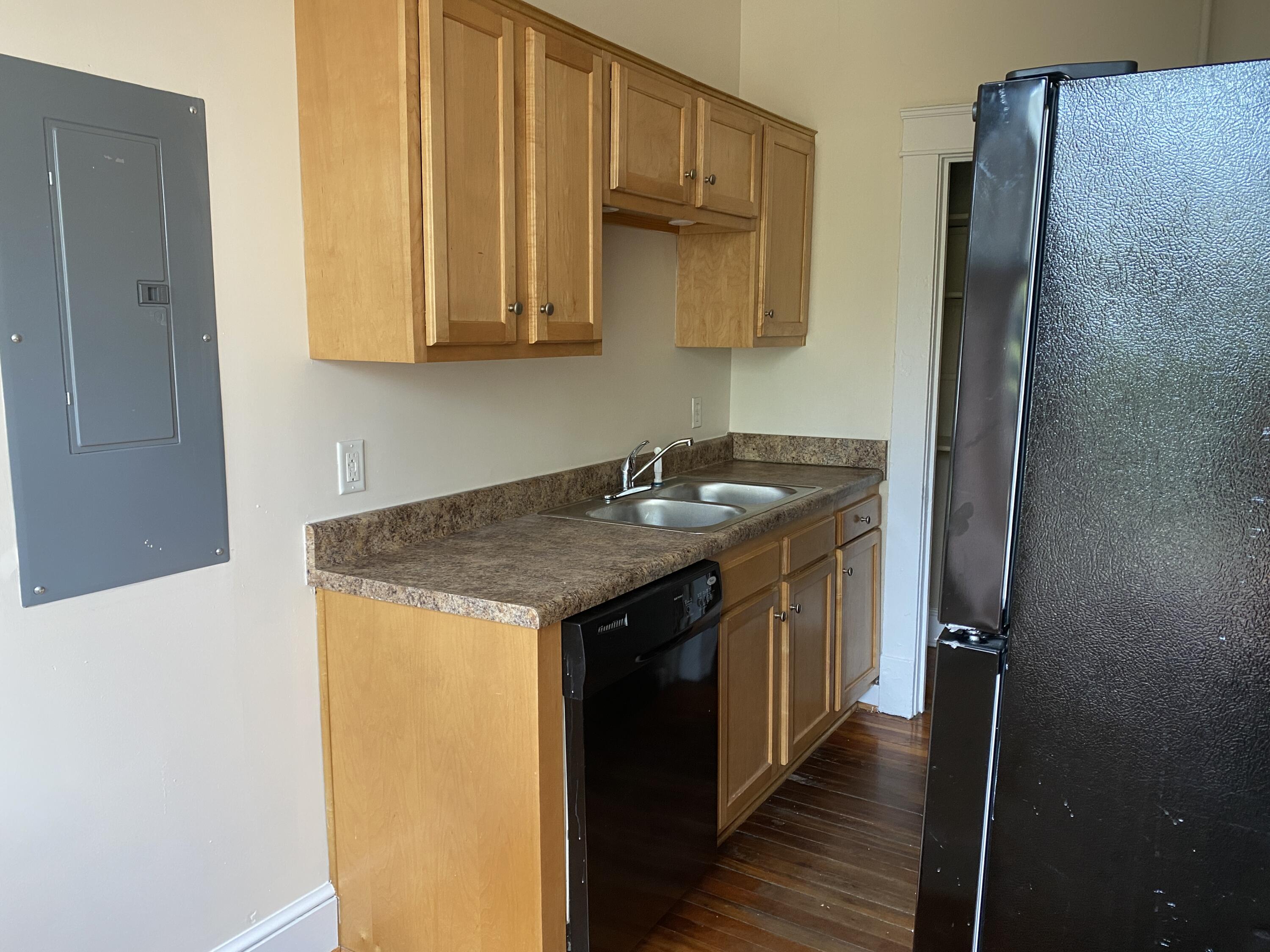 716 4th Street Southwest, Unit 4 Roanoke, VA 24016 - Photo 4 of 10 a kitchen with stainless steel appliances granite countertop a sink and a refrigerator