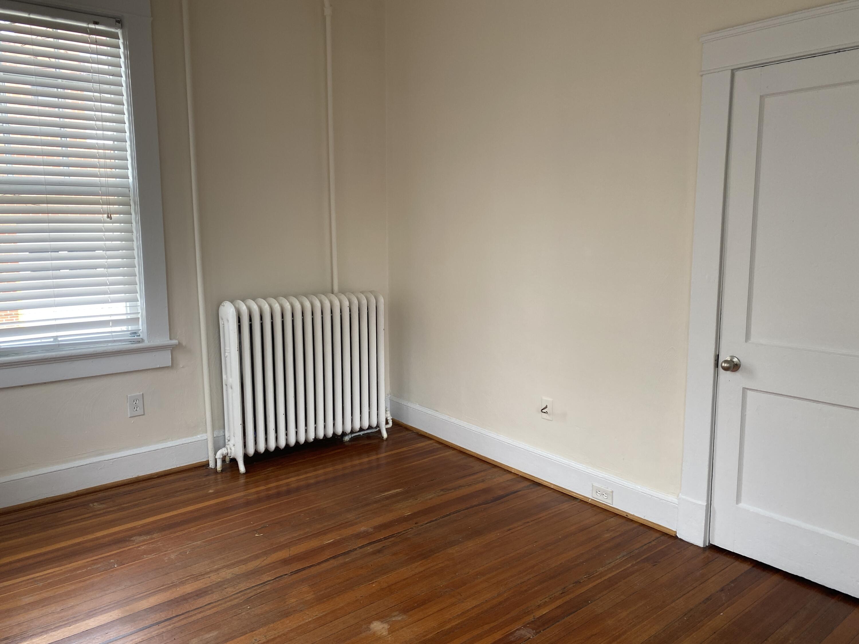 716 4th Street Southwest, Unit 4 Roanoke, VA 24016 - Photo 6 of 10 an empty room with wooden floor and windows