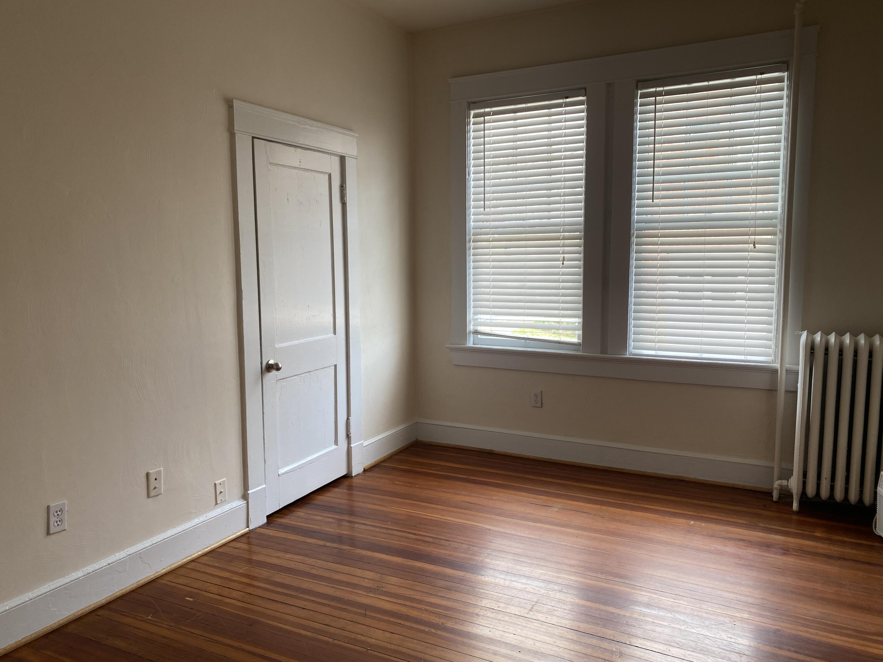716 4th Street Southwest, Unit 4 Roanoke, VA 24016 - Photo 7 of 10 an empty room with wooden floor and windows