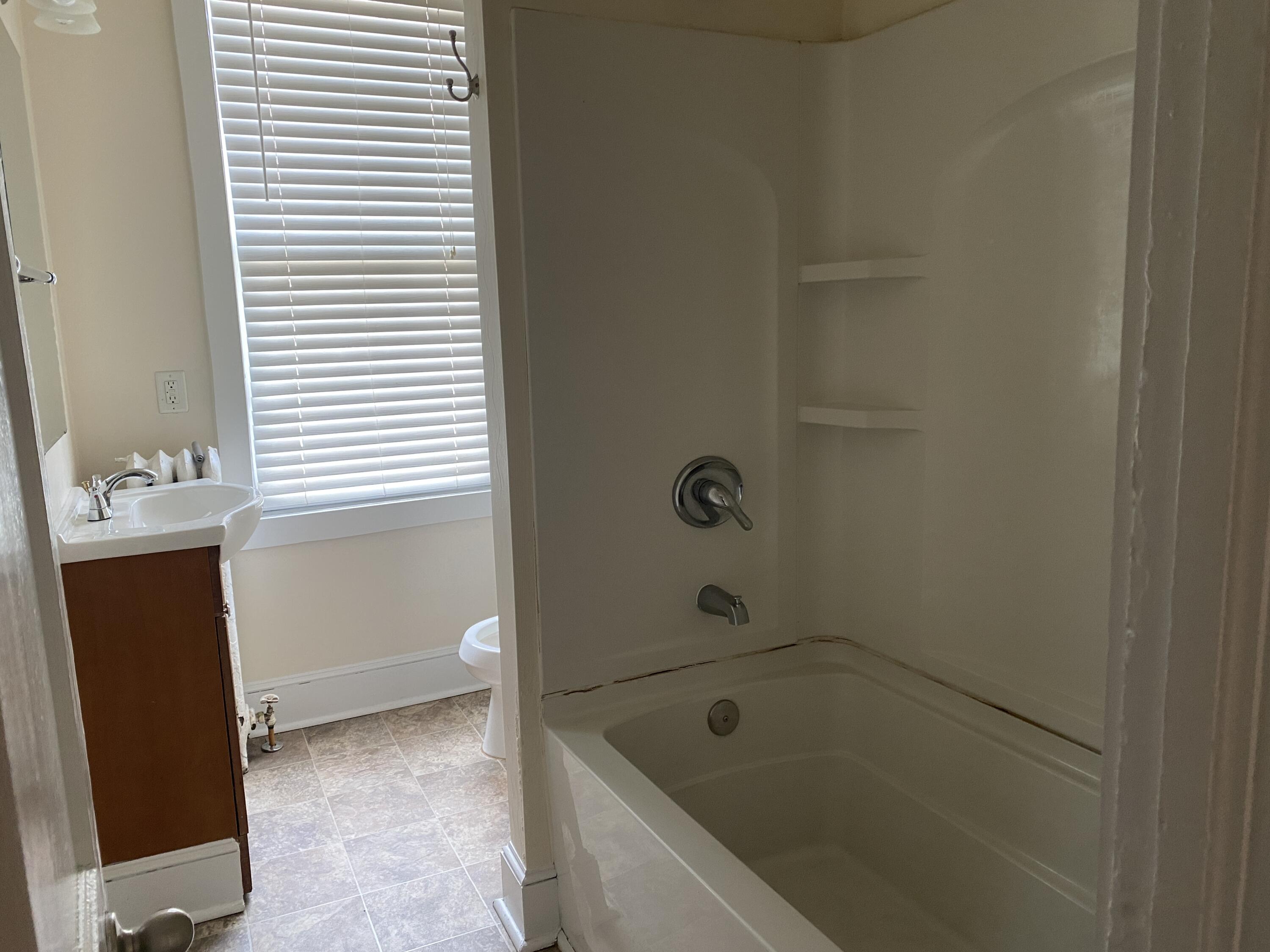 716 4th Street Southwest, Unit 4 Roanoke, VA 24016 - Photo 8 of 10 a bathroom with a tub and sink