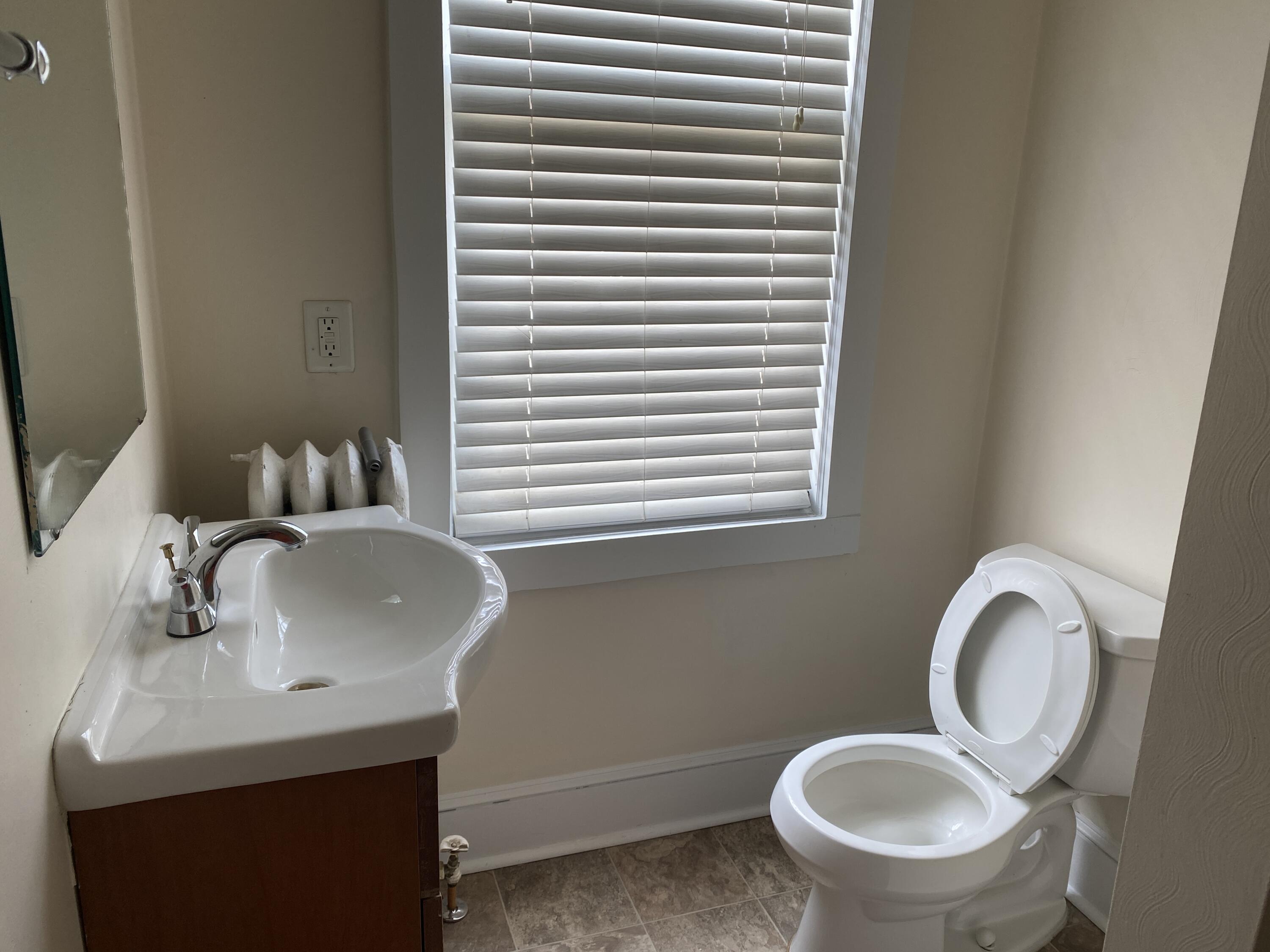 716 4th Street Southwest, Unit 4 Roanoke, VA 24016 - Photo 9 of 10 a bathroom with a toilet sink and mirror