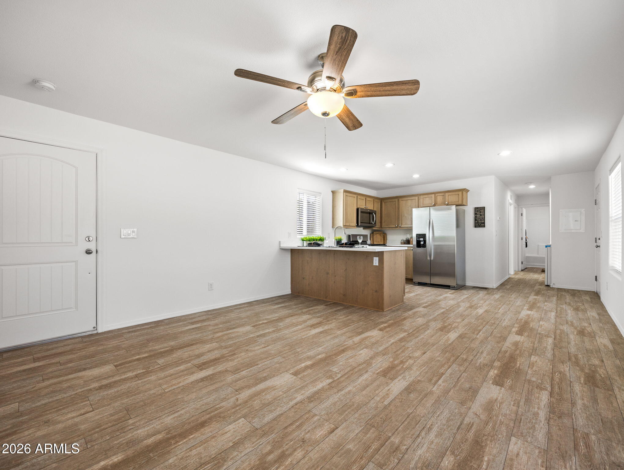 18296 Frontier Road Peeples Valley, AZ 86332 - Photo 10 of 44 a view of a livingroom with wooden floor and a ceiling fan