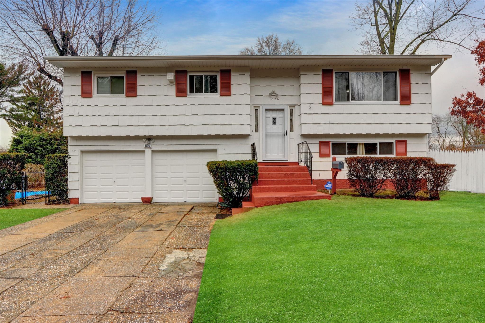 a front view of house with yard and outdoor seating