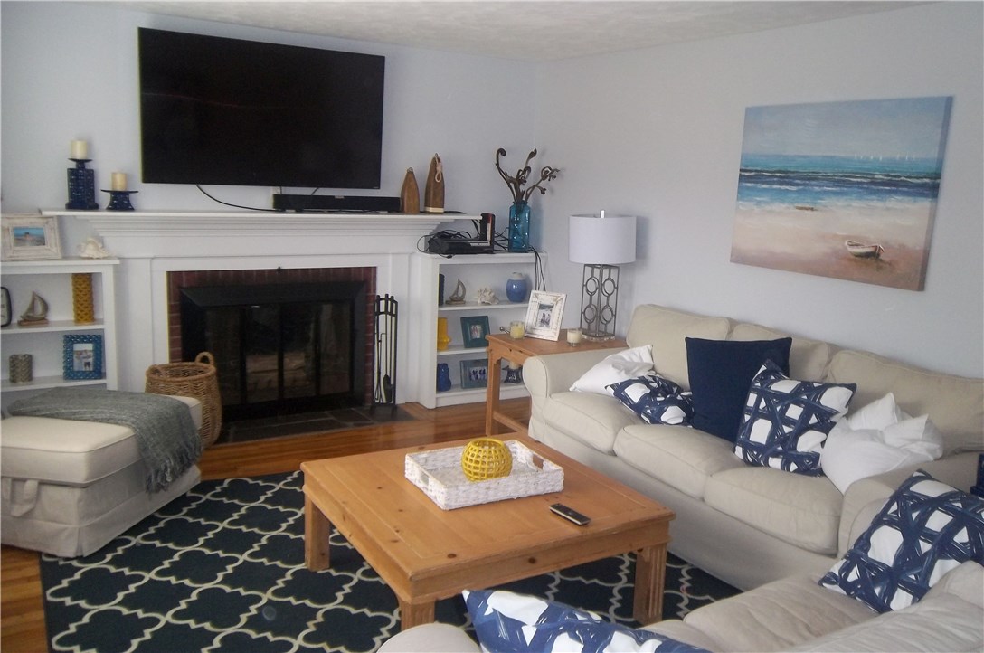 15 Phillips Road East Greenwich, RI 02818 - Photo 2 of 17 Nice size living room with brick fireplace, built-ins and hardwood floors.