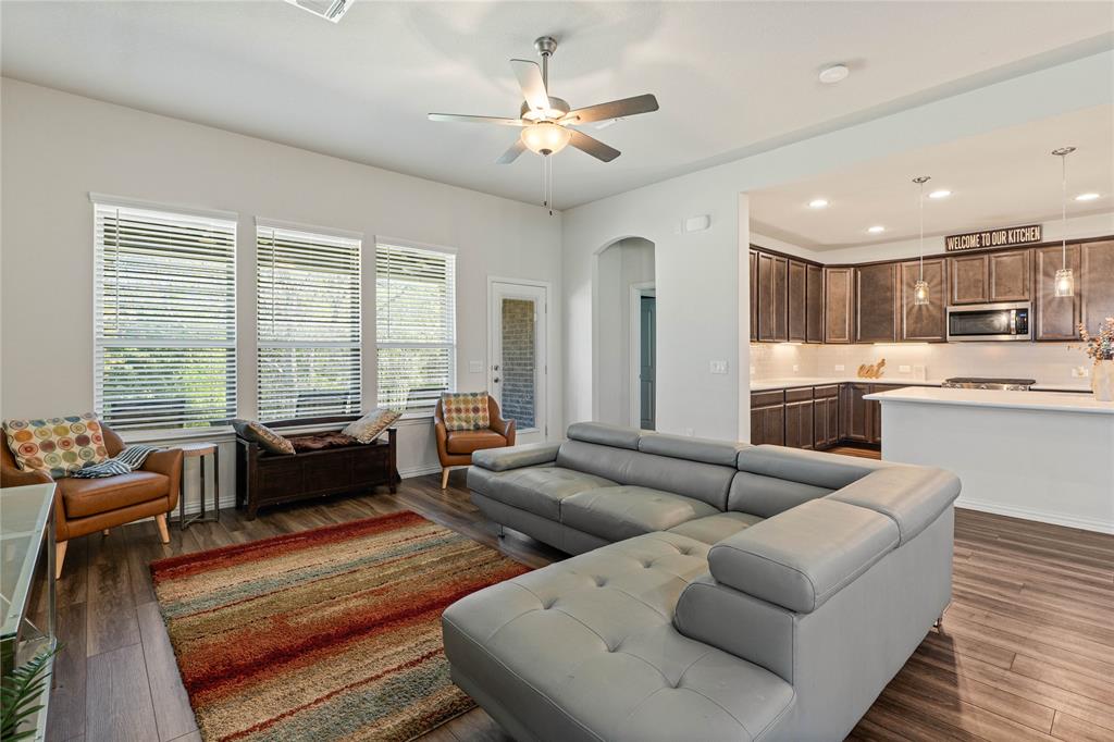 9517 Sunset Lane Oak Point, TX 75068 - Photo 12 of 40 9517 Sunset Lane, Oak Point, TX 75068 - living room - Living area with arched walkways, a ceiling fan, dark wood finished floors, and recessed lighting