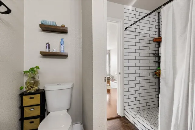 a white toilet sitting next to a bathroom sink