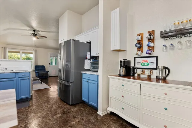 a kitchen with refrigerator cabinets and furniture