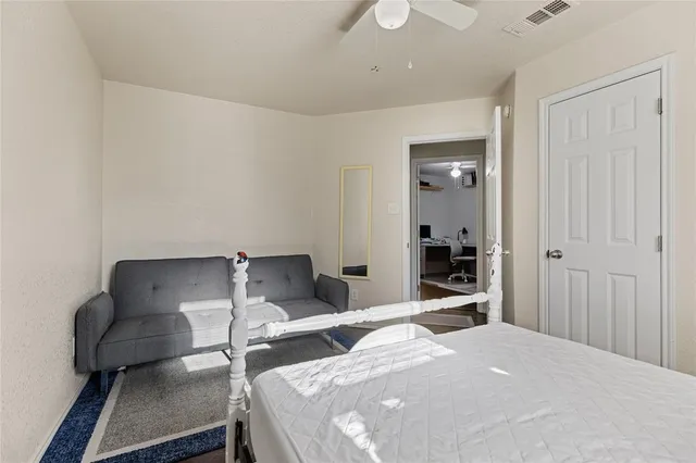 a bedroom with a bed and wooden floor