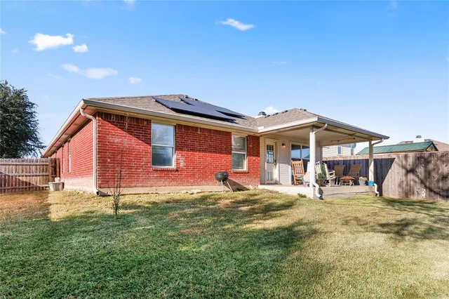 a front view of a house with a yard outdoor seating and garage