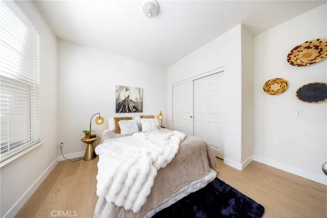 a bedroom with a bed and a window