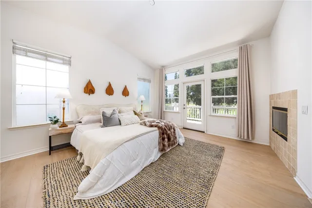 a bedroom with a bed and a large window with outer view