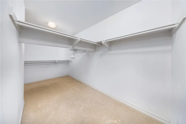 a view of a kitchen with wooden floor and cabinets