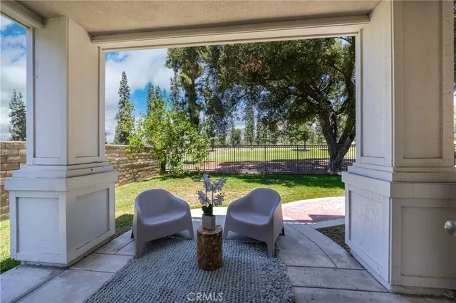 a view of a house with a yard and sitting area