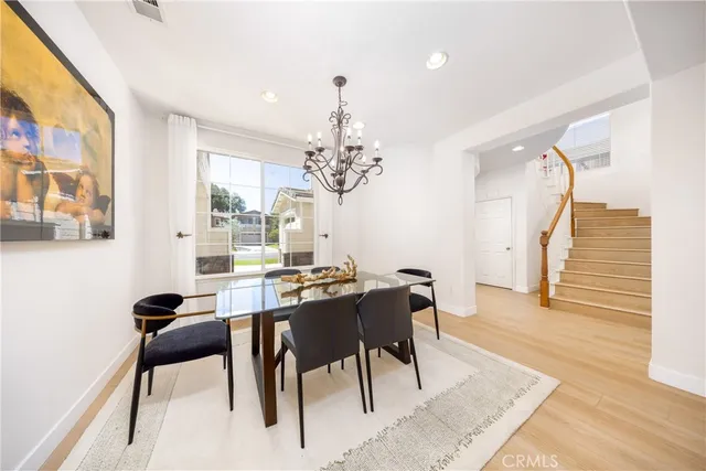 a view of a dining room with furniture and chandelier