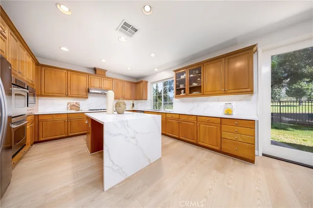 a large kitchen with stainless steel appliances lots of counter top space