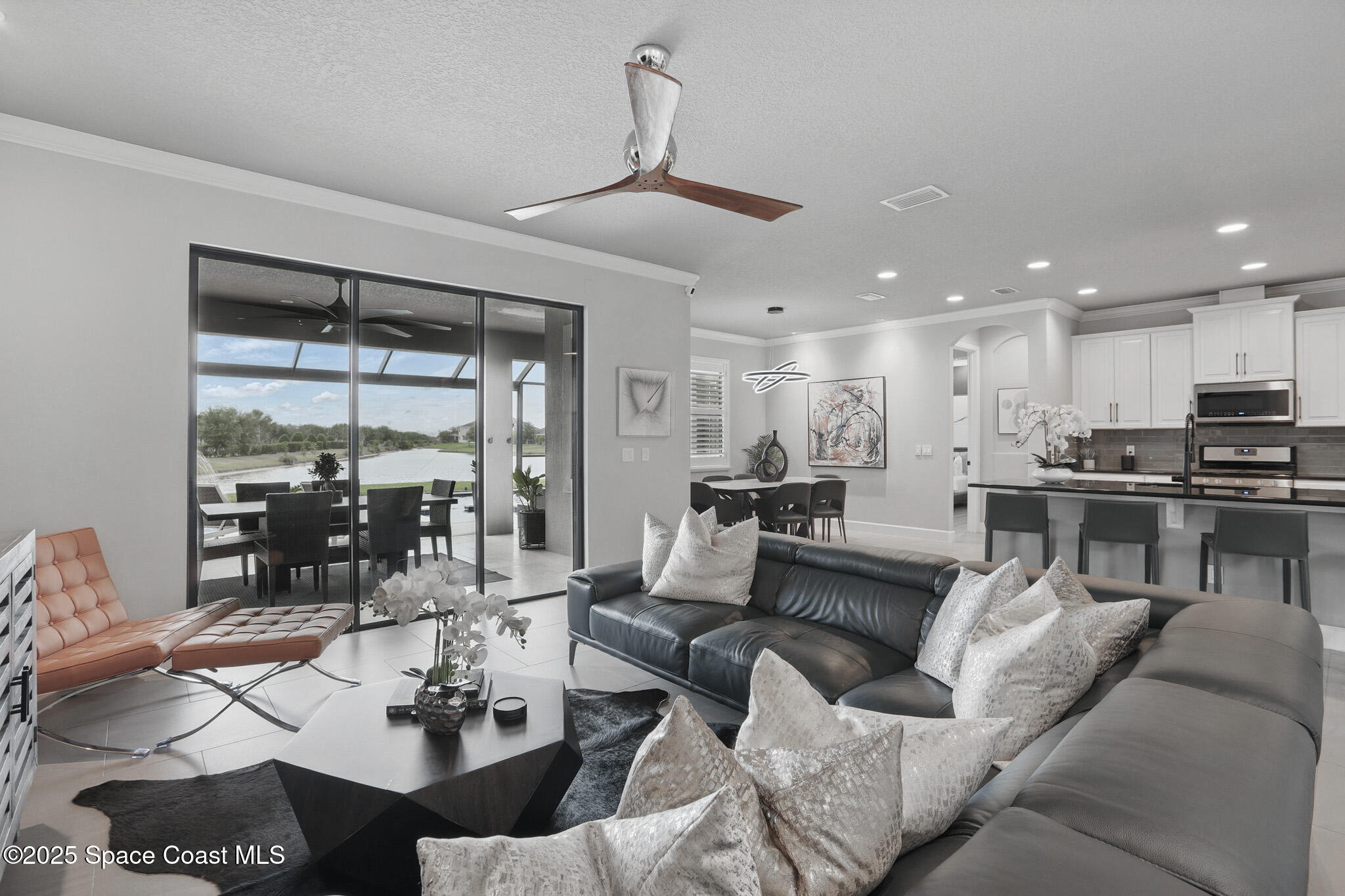 3222 Casterton Drive Melbourne, FL 32940 - Photo 11 of 67 a living room with furniture kitchen view and a large window