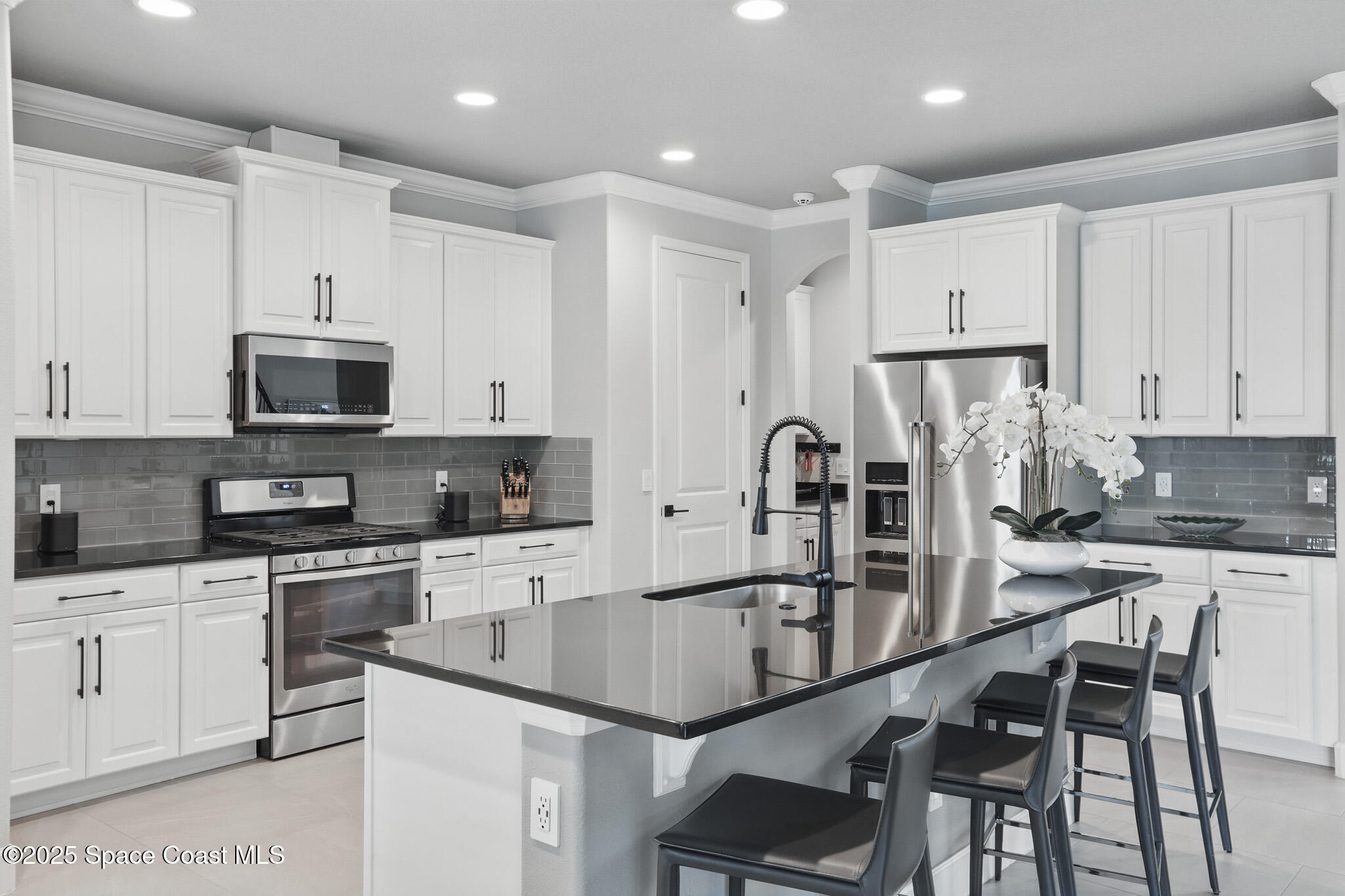 3222 Casterton Drive Melbourne, FL 32940 - Photo 13 of 67 a kitchen with kitchen island granite countertop a sink counter top space appliances and cabinets