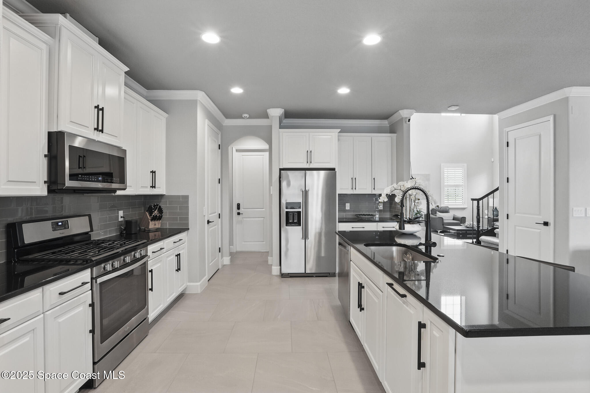 3222 Casterton Drive Melbourne, FL 32940 - Photo 14 of 67 a large kitchen with stainless steel appliances granite countertop a lot of counter space and wooden cabinets