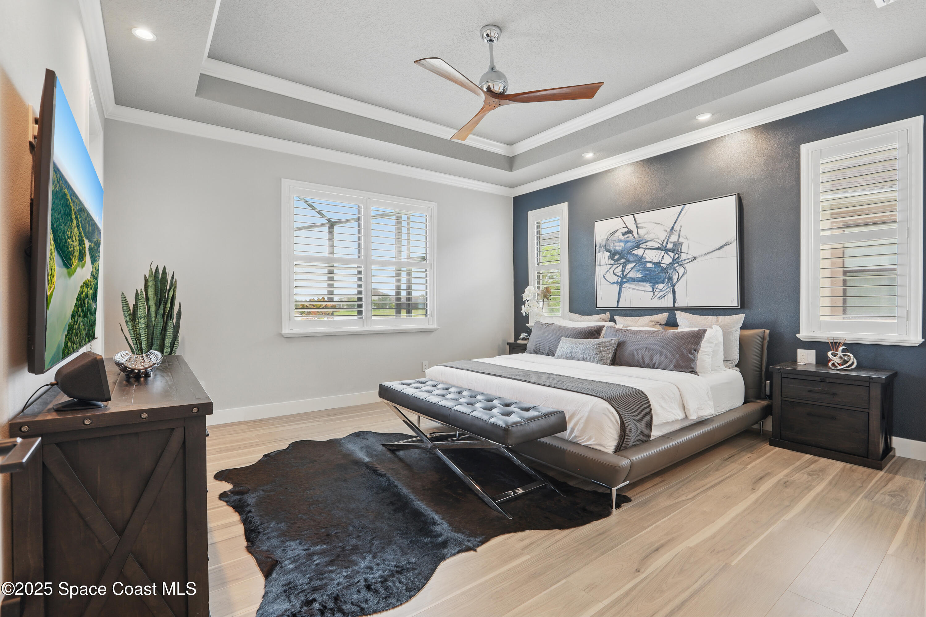 3222 Casterton Drive Melbourne, FL 32940 - Photo 18 of 67 a bedroom with a bed and wooden floor