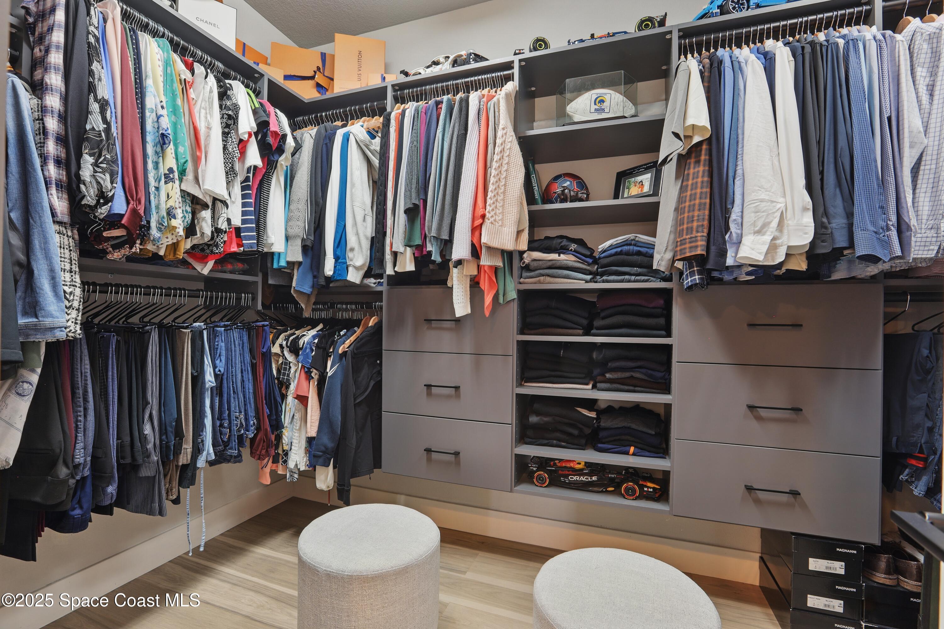 3222 Casterton Drive Melbourne, FL 32940 - Photo 25 of 67 a view of walk in closet with clothes and shoes