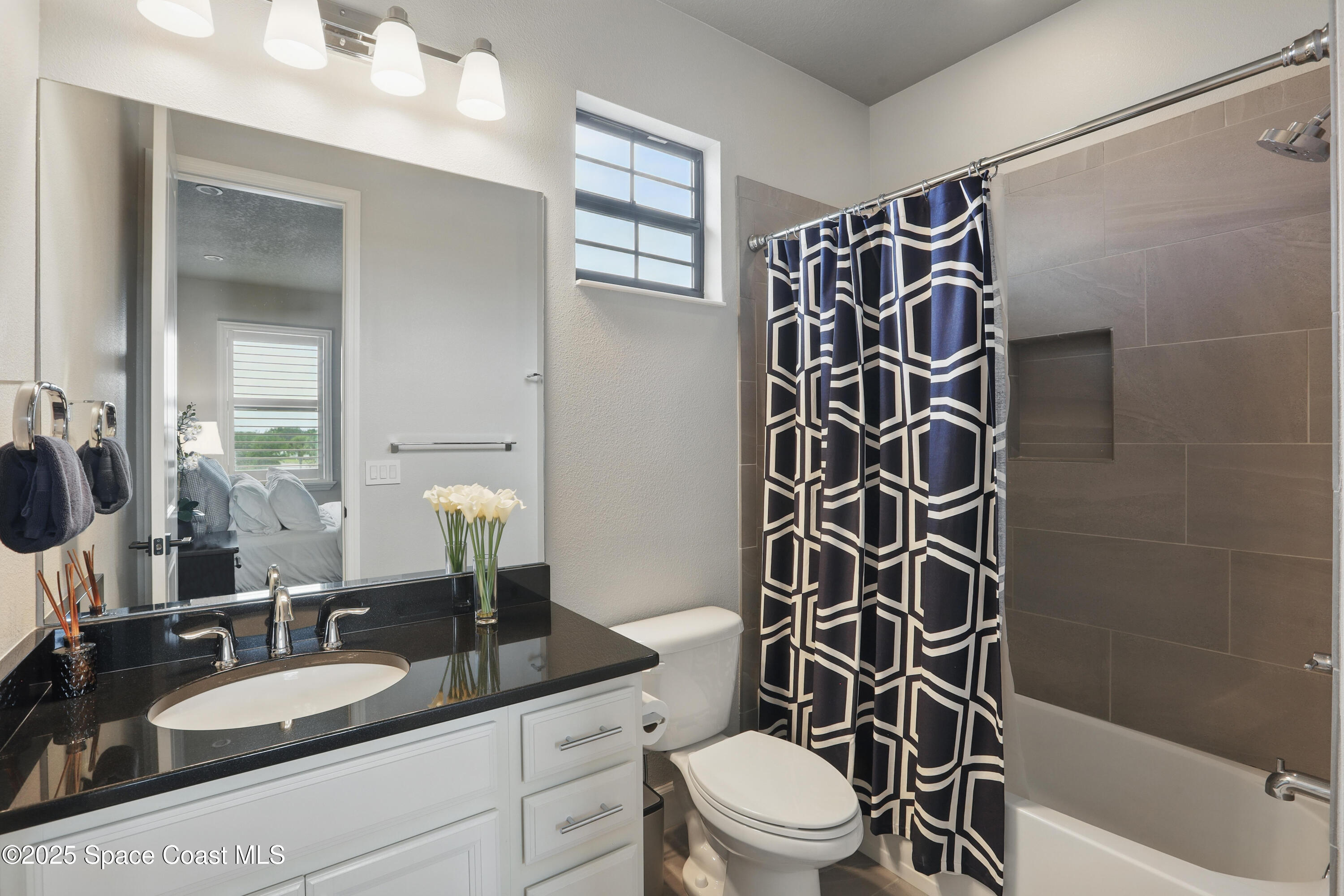 3222 Casterton Drive Melbourne, FL 32940 - Photo 33 of 67 a bathroom with a granite countertop sink toilet a mirror and shower