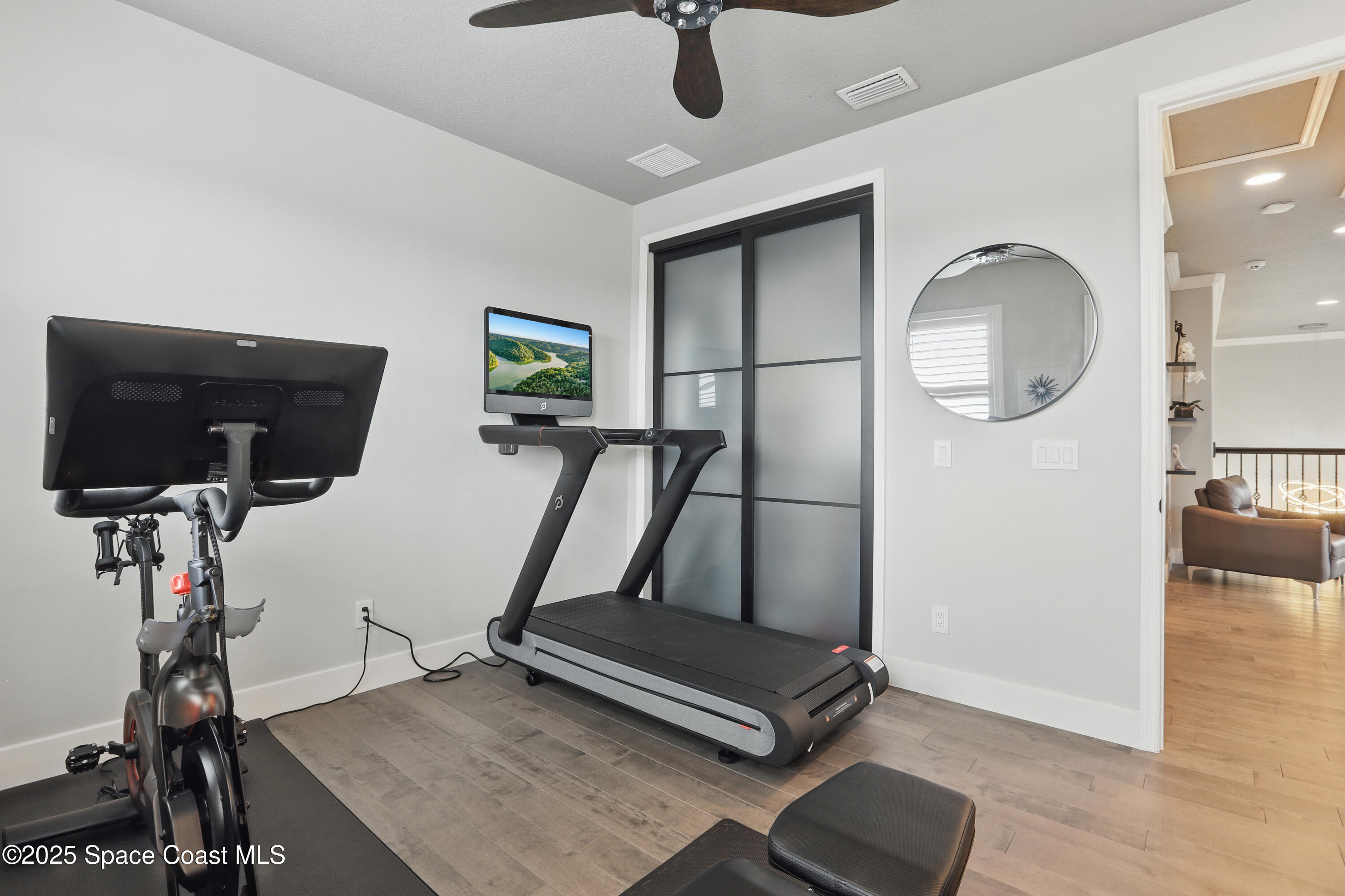 3222 Casterton Drive Melbourne, FL 32940 - Photo 37 of 67 a room with gym equipment and a view of living room