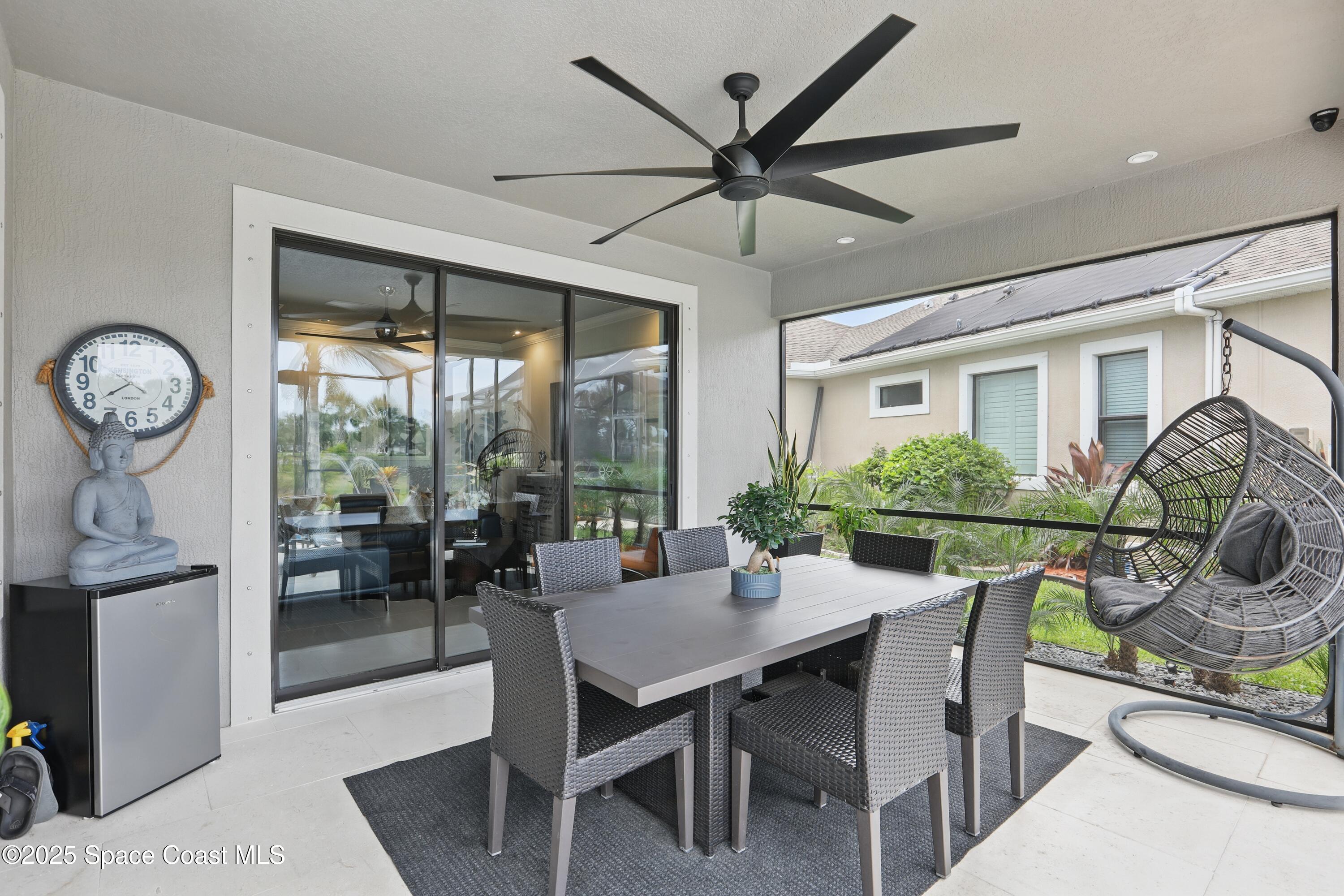 3222 Casterton Drive Melbourne, FL 32940 - Photo 40 of 67 a dining room with furniture a large window and a chandelier