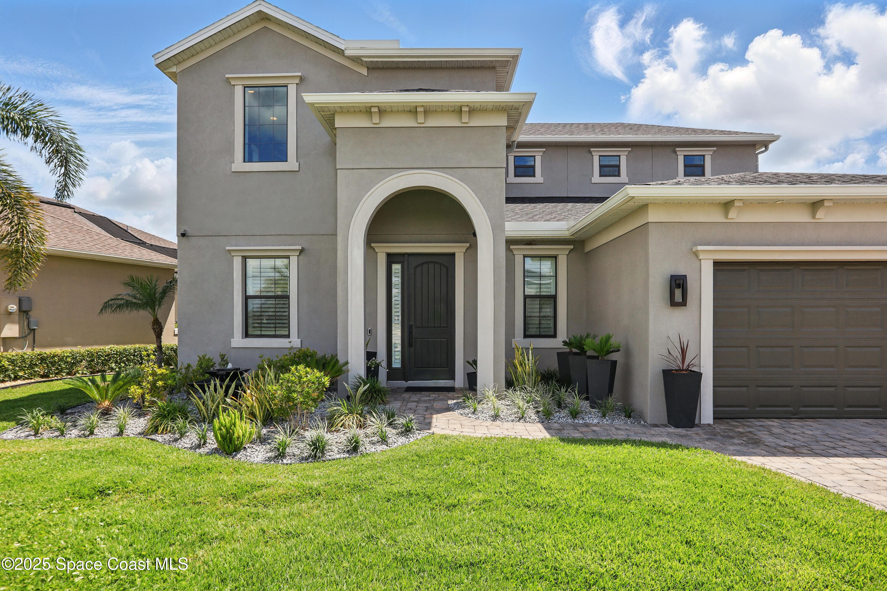 3222 Casterton Drive Melbourne, FL 32940 - Photo 46 of 67 a front view of a house with a yard