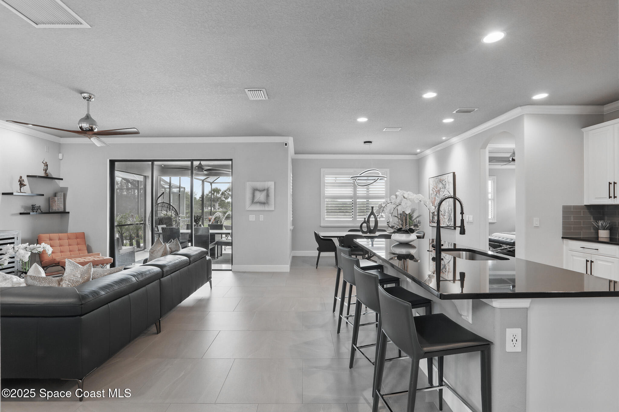 3222 Casterton Drive Melbourne, FL 32940 - Photo 7 of 67 a living room with furniture a flat screen tv and a large window