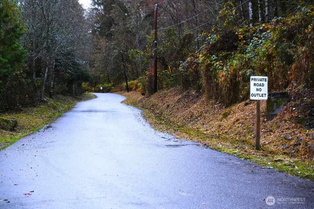 a view of a street with trees on both side of it