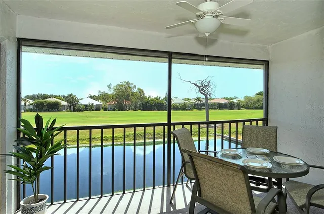 a view of a porch with a table and chairs